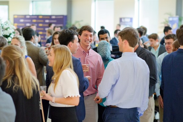 group of people in a crowded room talking 