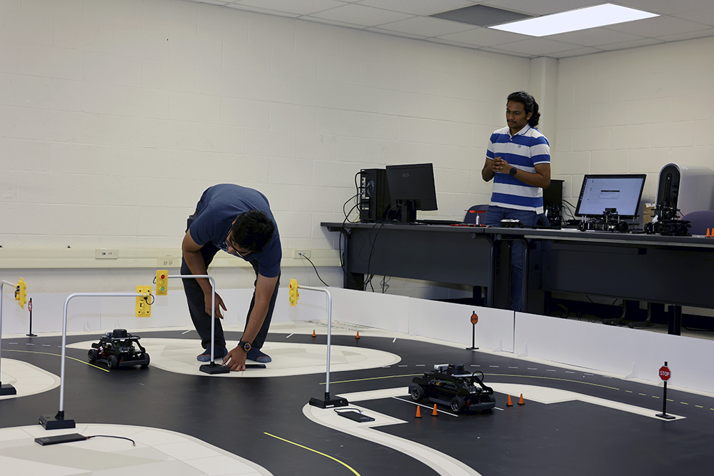 Students work on the test track and vehicles