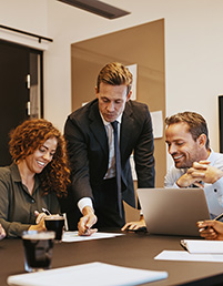Professionals collaborating around a table during a planning meeting.