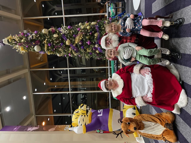 Santa Claus and Mrs. Claus with children